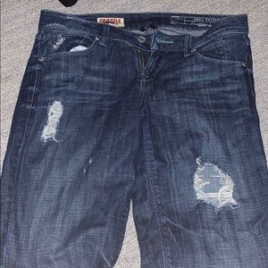 Ripped blue jeans. Straight cut.